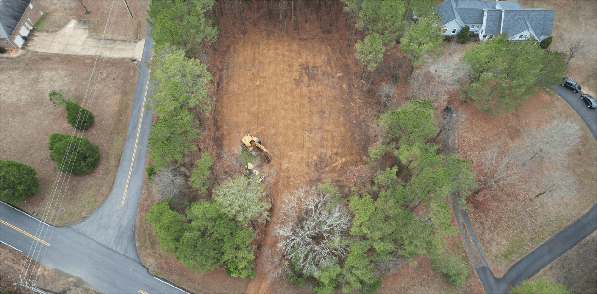 Aerial view of a cleared building pad with equipment
